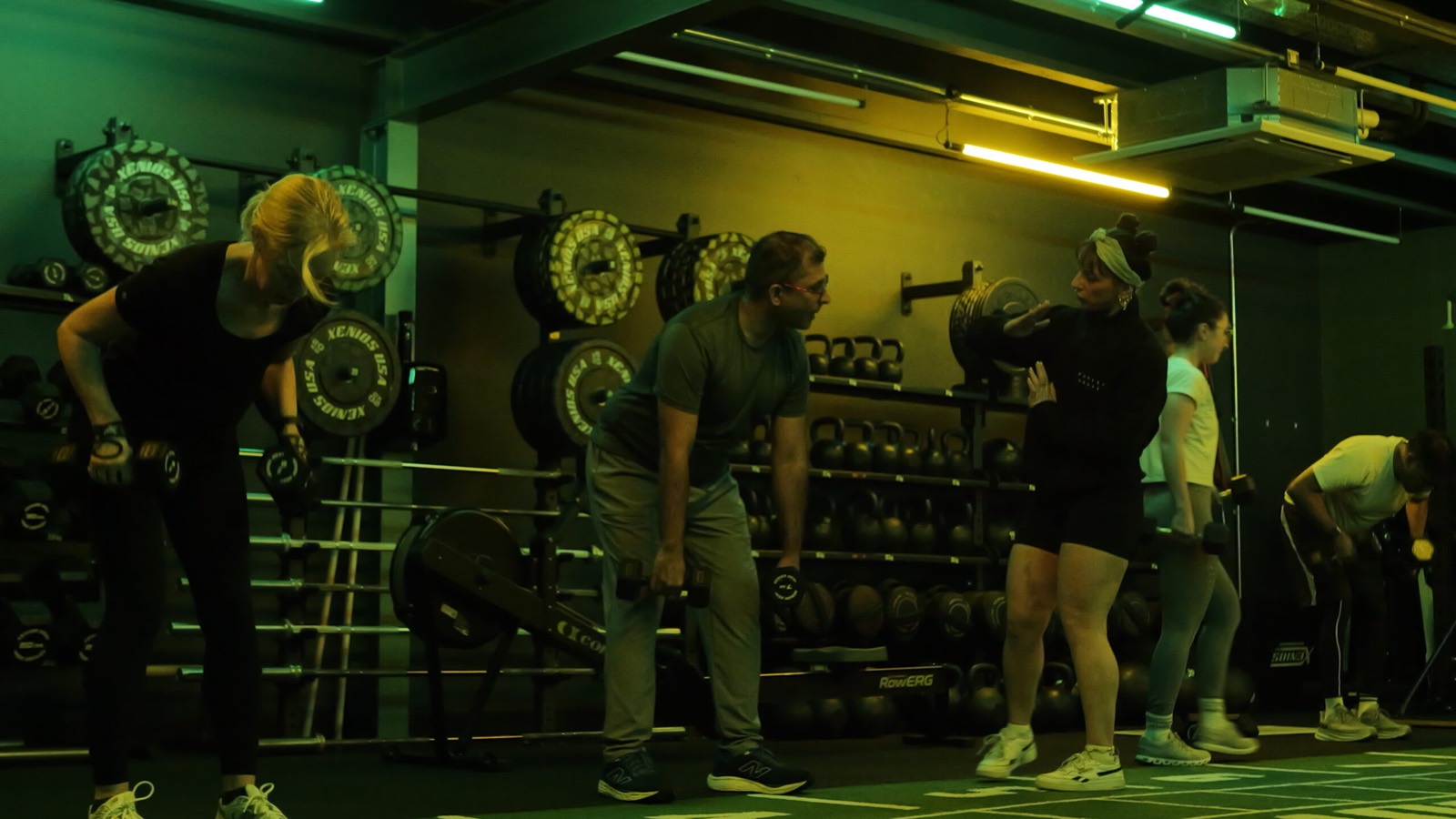 Coach working one-to-one with members in the Functional studio