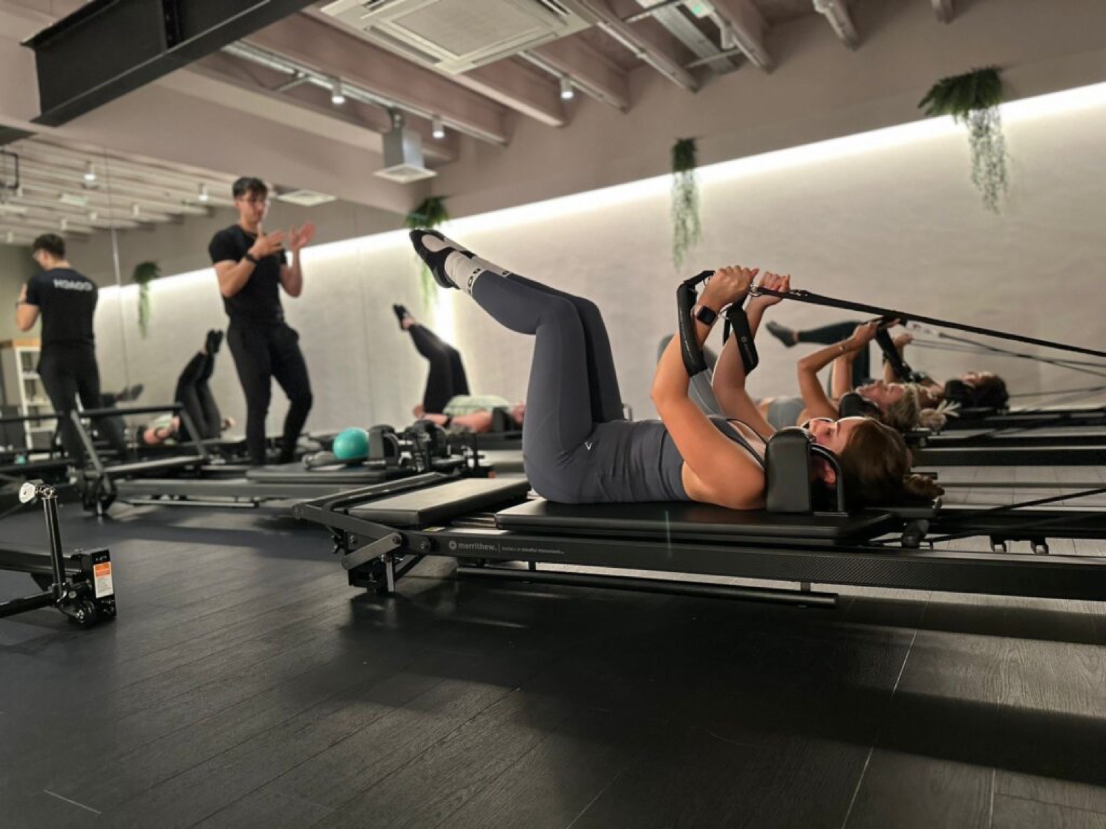 Reformer Pilates class in the eight-bed studio